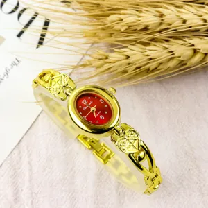 Vintage womens oval dial quartz watch with cute heart bracelet strap and red dial detail.