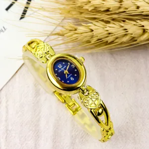 Elegant women's quartz watch with oval dial and heart bracelet link design in gold.
