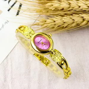 Details of the vintage women quartz watch with oval pink dial and heart link chain strap.