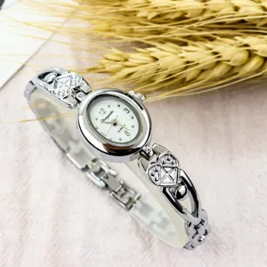 Women's retro minimalist quartz watch with oval dial and heart bracelet strap for daily wear.