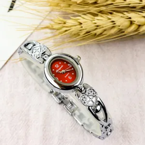 Elegant vintage women quartz watch with red oval dial and sparkling heart bracelet.