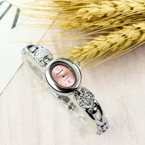 Women's vintage minimalist bracelet watch with small oval dial and heart strap quartz watch.