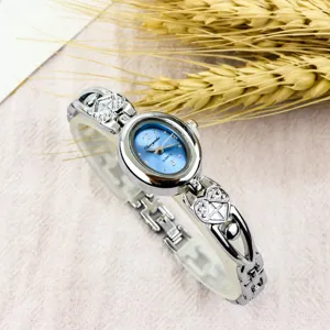 Detail shot of the elegant women's quartz watch featuring a blue oval dial and heart links.