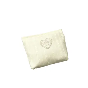 Cream white striped cosmetic pouch with cute bow heart embroidery for travel storage.