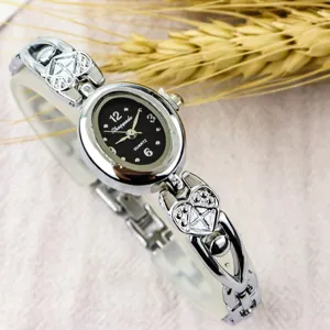 Women vintage minimalist bracelet quartz watch with oval small dial and lovely heart strap.