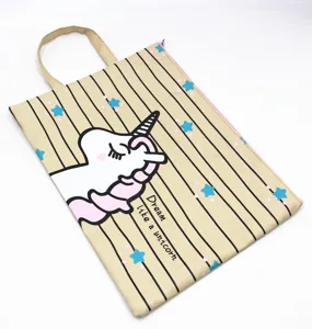 Detailed shot of cute cartoon unicorn canvas A4 document bag with handle and zipper closure.
