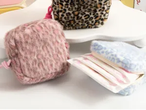 Plush leopard print sanitary napkin pouch detail view, soft portable makeup storage bag.