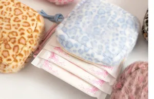 Plush leopard print sanitary napkin storage pouch detail, soft material cosmetic bag showcase