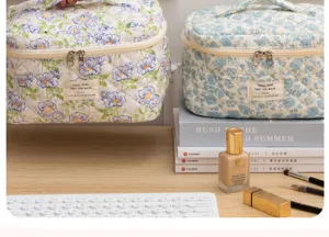 Quilted floral cosmetic bag, portable travel makeup storage pouch with cute floral print.