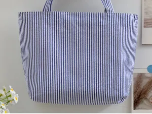 Close-up view of the blue and white striped tote bag showing detailed fabric texture and design.