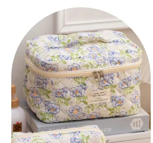 Quilted floral makeup bag, cute portable cosmetic travel organizer with handle and zipper.
