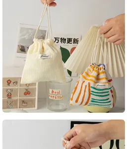 Corduroy drawstring storage bag, portable cosmetic pouch for women, mini coin purse detail.