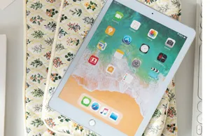Floral quilted tablet sleeve protective case detail view showing device storage fit.