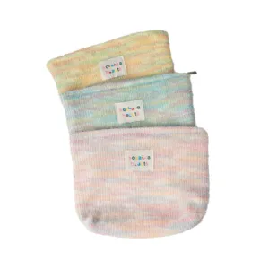 Fluffy rainbow cosmetic bag for women, large capacity plush makeup pouch for travel and wash.