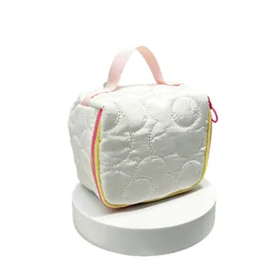 White quilted cosmetic bag with pink handle and zipper, cute travel toiletry pouch for women and girls.
