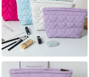 Quilted heart cosmetic bag detail showing soft fabric texture, zipper closure and cute aesthetic.