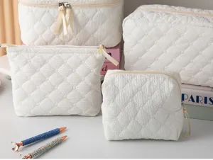 White quilted cosmetic bags detail view showing large capacity and soft textured surface design.