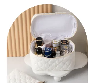 White quilted cosmetic bag with large capacity, stylish travel toiletry pouch for women.