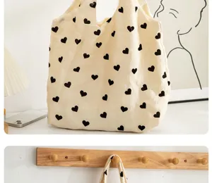 Canvas tote bag with cute black heart print, large capacity casual shoulder handbag for daily use.