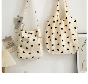 Cute aesthetic canvas tote and shoulder bag set featuring classic black heart prints for daily use.