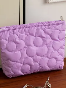 Purple quilted flower cosmetic bag, soft travel makeup pouch with secure zipper closure.