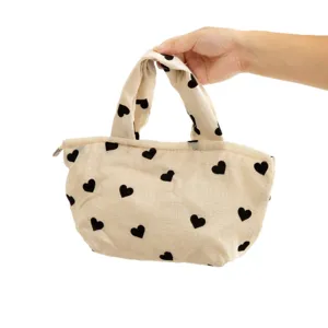 Beige plush handbag with black heart print, soft portable cosmetic makeup bag cute tote.