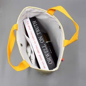 Détail intérieur du sac cabas en velours côtelé montrant une grande capacité de rangement.