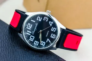 Detail view of the men's black and red silicone quartz watch, bold numbers dial.