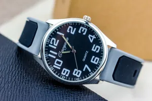 Men's quartz watch with sleek silicone strap, black dial, and large bold Arabic numerals.