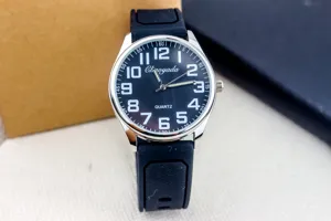 Detailed close-up of men's quartz watch with black silicone strap and clear white Arabic numerals.