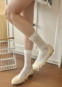 Detailed view of women sweet lace mesh mid-calf socks featuring cute bow and floral pattern.