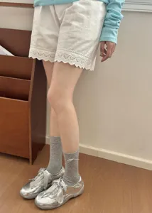 Detailed shot of sweet Korean style grey mid-tube slouch socks with cute bows and shoes.