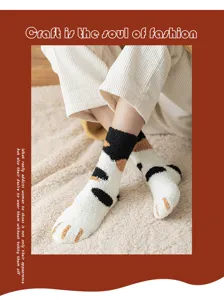 Cozy plush cat paw socks detail, soft coral fleece for warm winter home lounging.
