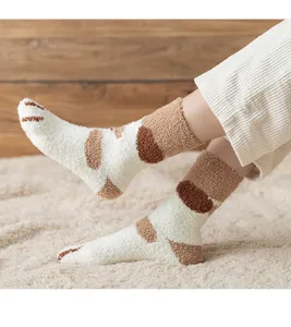 Cozy fuzzy coral velvet cat paw socks, soft indoor sleep floor socks close-up view.