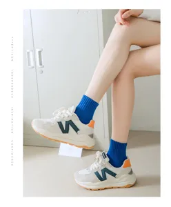 Stylish blue mid-calf cotton socks paired with retro chunky sneakers for women trend.