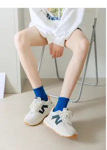 Blue mid-tube socks paired with casual white sneakers for women summer wear detail.