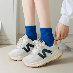 Stylish women's casual sneakers with breathable mesh, comfortable lace-up design.