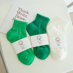 Solid color cotton short socks for women, breathable summer green and white casual ankle socks.