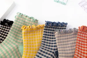 Close up view of cute retro plaid cotton socks with lettuce edge, detailed texture and colors.