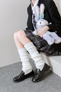 White knitted leg warmers detail view, cozy winter boot covers for JK style outfits.