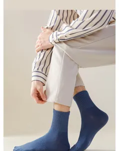 Detail view of men's solid blue ribbed crew socks, comfortable cotton knit fabric texture.