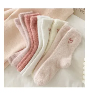 Plush mink fleece warm winter mid-tube women socks with cute heart embroidery detail.