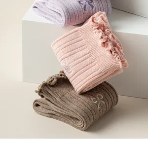 Close-up detail of women's ribbed ruffle socks featuring cute bow embroidery and soft fabric.