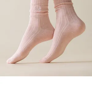 Pink ribbed knit mid-tube socks featuring a cute white embroidered bow for daily wear.