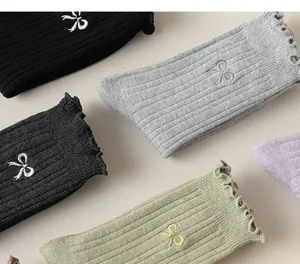 Ribbed women's socks with cute bow embroidery and ruffled cuff design for autumn winter daily.