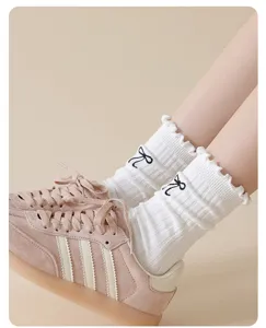 Women cute cotton mid-tube socks featuring sweet bow embroidery and ruffle cuffs for daily wear.