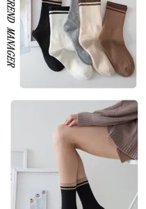 Detail shot of women striped mid-tube socks in multiple colors, soft ribbed knit design.