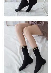 Black mid-calf socks with striped ribbed cuffs, detail view of casual daily hosiery.