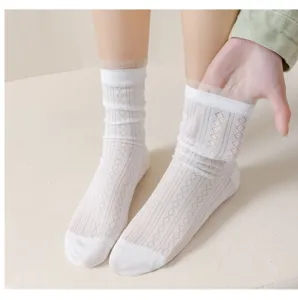 Detail view of white sheer mesh crew socks with diamond pattern showing soft texture and elastic stretch.
