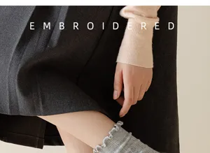 Detail view of women lace embroidered mid-tube socks, stylish autumn winter daily wear.